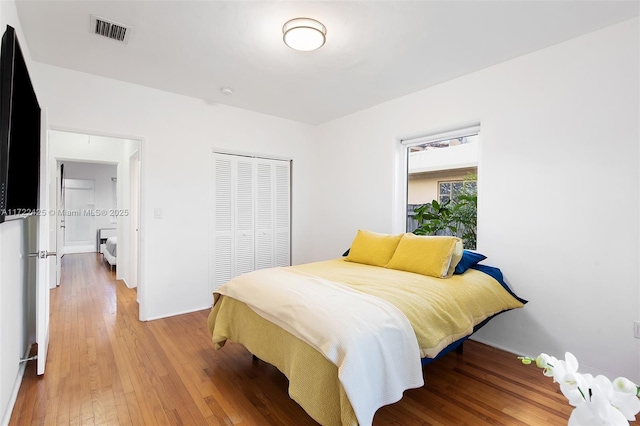 bedroom with hardwood / wood-style flooring and a closet