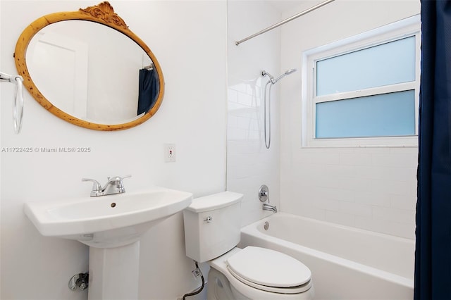 bathroom featuring tiled shower / bath and toilet