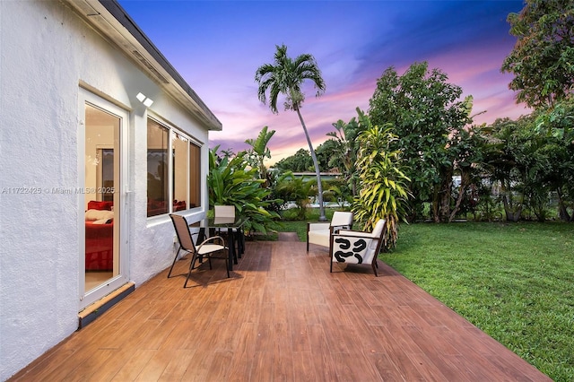 patio terrace at dusk with a lawn