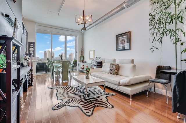 living room with light hardwood / wood-style flooring and a notable chandelier