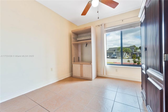 interior space with ceiling fan and light tile patterned flooring