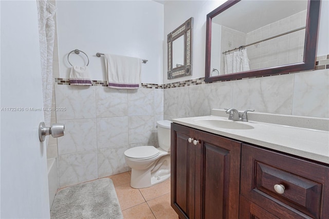 bathroom featuring walk in shower, tile patterned floors, toilet, vanity, and tile walls