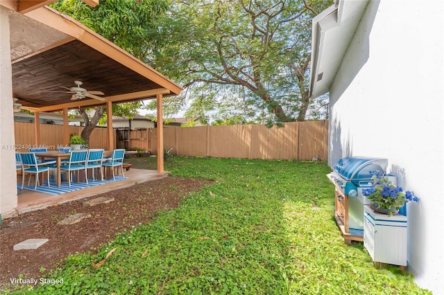 view of yard with a patio and ceiling fan