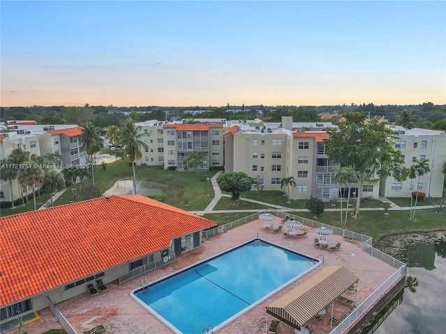 view of pool at dusk