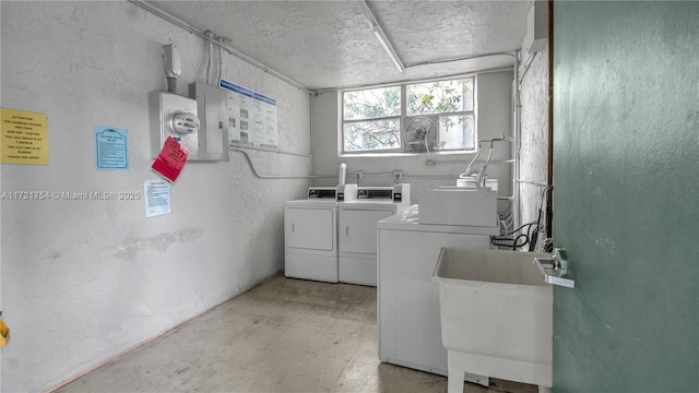 laundry area featuring sink and washer and dryer