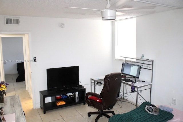 tiled office space with a textured ceiling