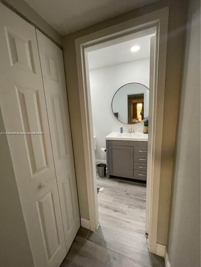 corridor featuring light hardwood / wood-style floors and sink