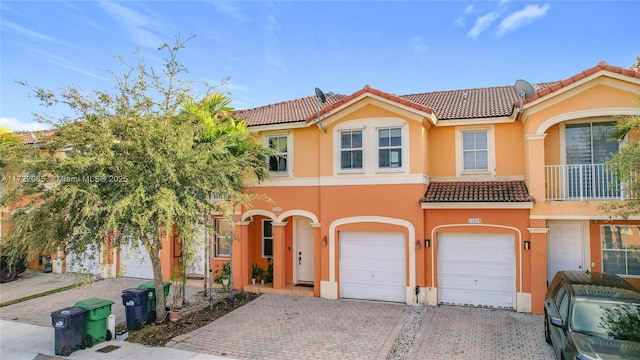 mediterranean / spanish-style home with a garage