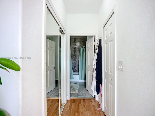 corridor with light hardwood / wood-style flooring