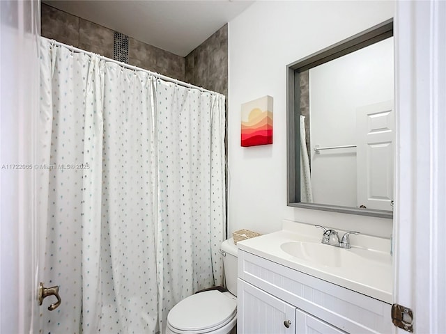 bathroom with toilet, walk in shower, and vanity