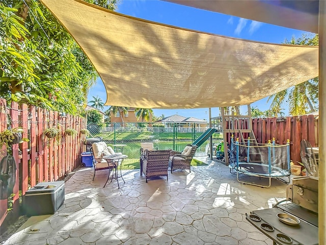 view of patio with a playground, outdoor lounge area, and a trampoline