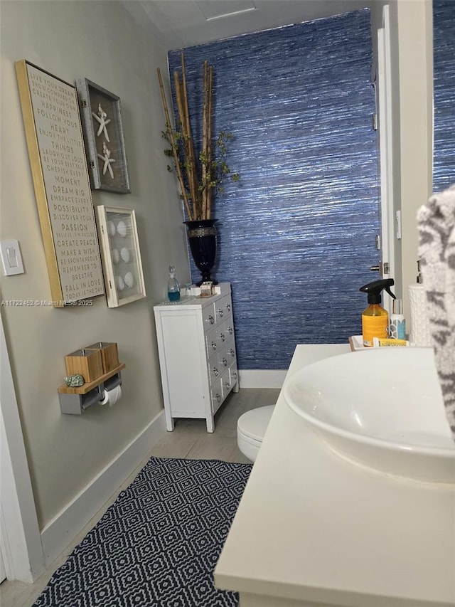 bathroom featuring tile patterned flooring, vanity, and toilet