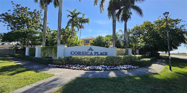 community / neighborhood sign with a lawn