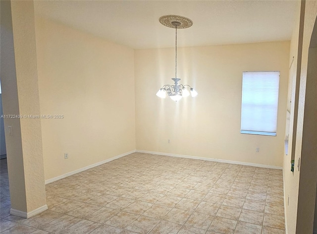 spare room with a notable chandelier