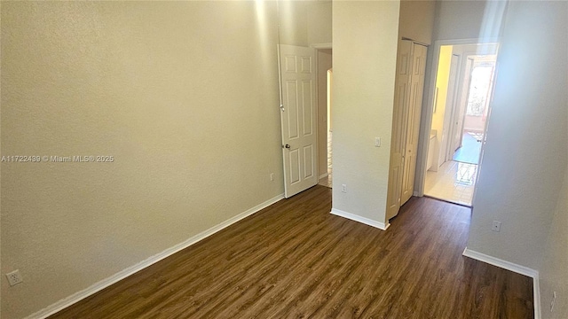 hallway with dark hardwood / wood-style flooring