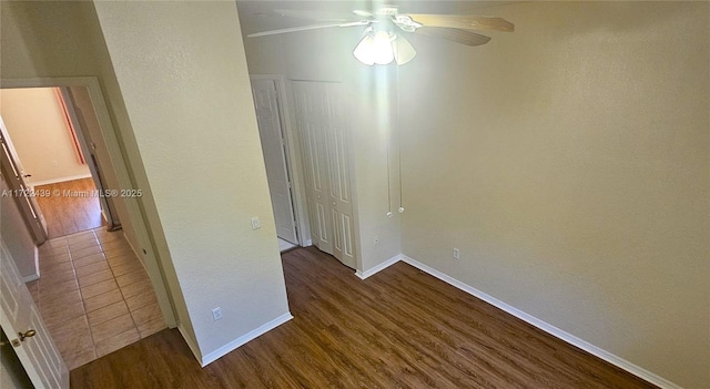 empty room with ceiling fan and hardwood / wood-style flooring