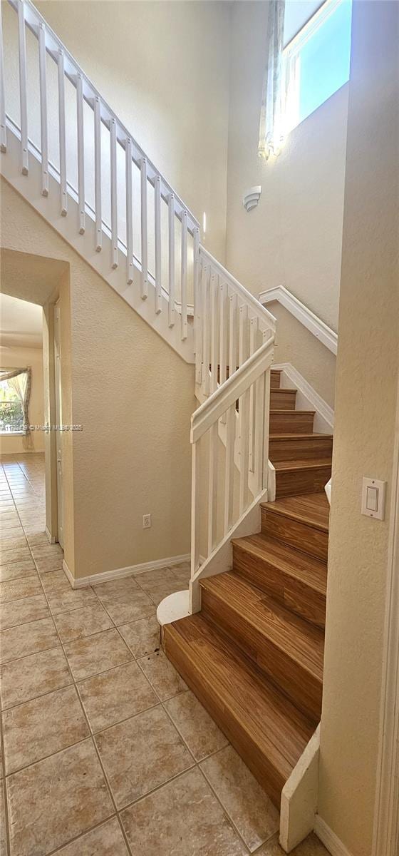 stairway with tile patterned floors