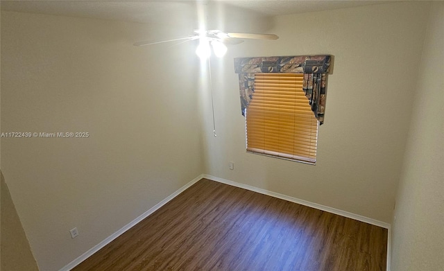 spare room featuring hardwood / wood-style floors and ceiling fan