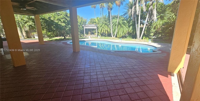 view of pool with ceiling fan and a patio area