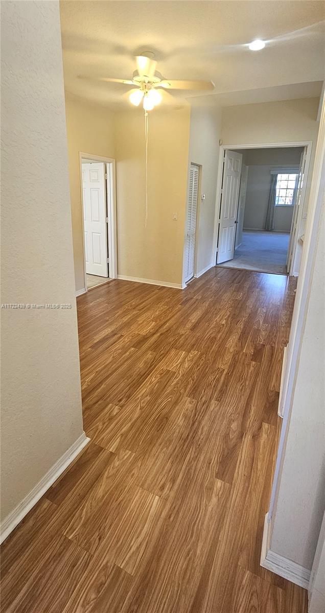 spare room with hardwood / wood-style floors and ceiling fan