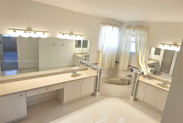 bathroom with tile patterned floors, vanity, and a tub to relax in