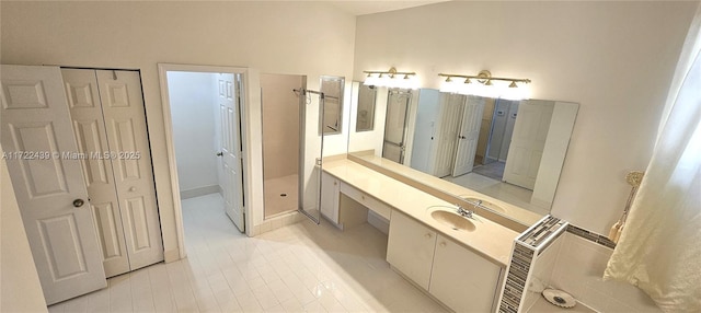 bathroom featuring tile patterned flooring, vanity, and walk in shower