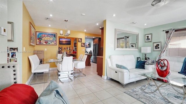 tiled living room with a wealth of natural light and an inviting chandelier