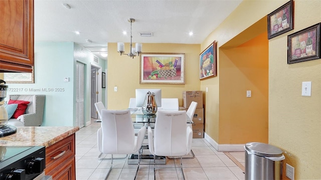 tiled dining area with a notable chandelier