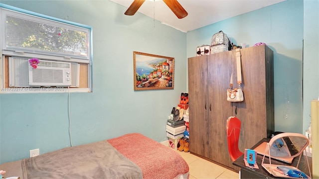 tiled bedroom with ceiling fan and cooling unit