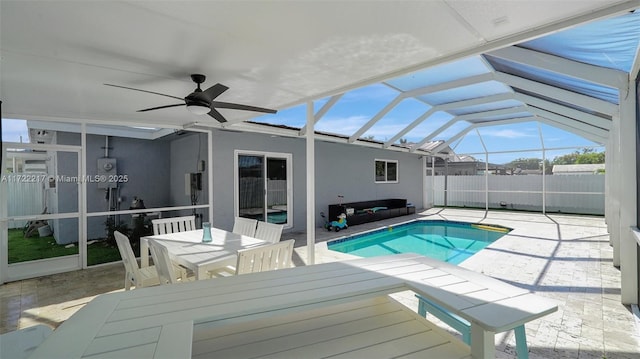 view of pool featuring a patio, ceiling fan, and a lanai