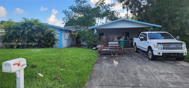 view of front of property with a front lawn and a carport