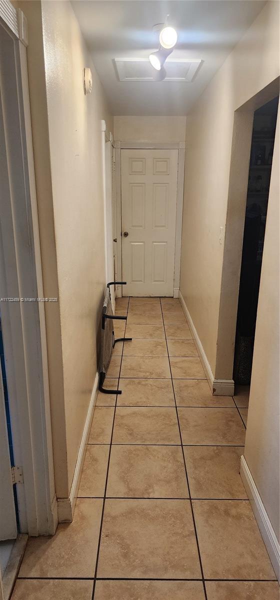 corridor with light tile patterned flooring