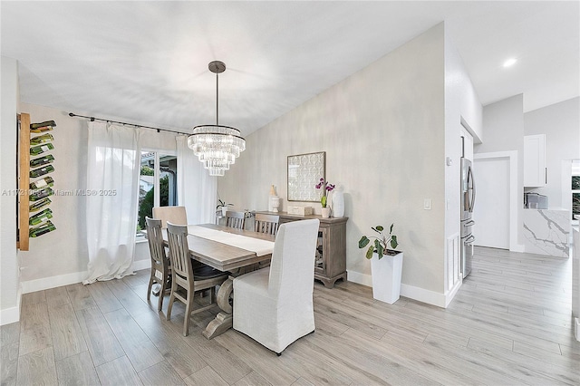 dining room featuring a chandelier and light hardwood / wood-style floors