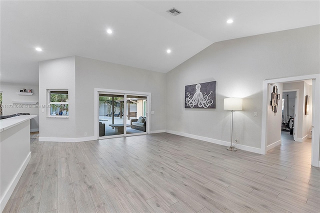 unfurnished living room with high vaulted ceiling and light hardwood / wood-style flooring