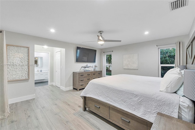 bedroom featuring ceiling fan, light wood-type flooring, and ensuite bathroom