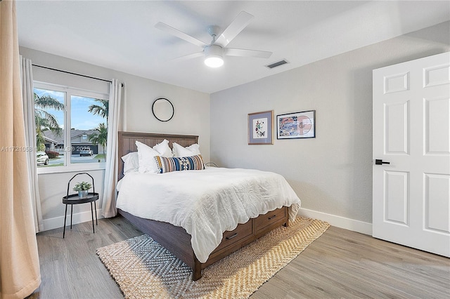 bedroom with light wood-type flooring and ceiling fan