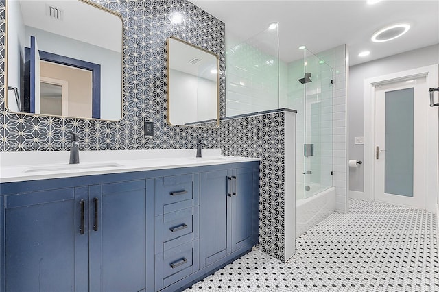 bathroom featuring vanity and combined bath / shower with glass door