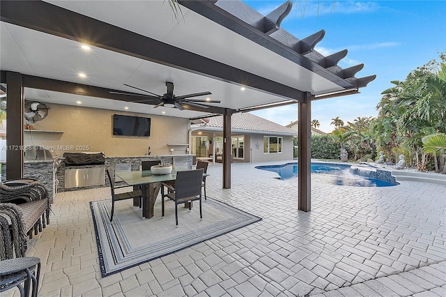 view of patio / terrace featuring grilling area, ceiling fan, sink, and exterior kitchen