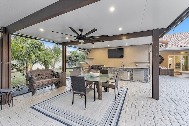 view of patio with an outdoor kitchen, outdoor lounge area, ceiling fan, sink, and grilling area