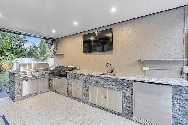 view of patio / terrace with area for grilling, sink, and exterior kitchen