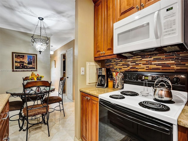 kitchen featuring a notable chandelier, backsplash, decorative light fixtures, white appliances, and light tile patterned floors