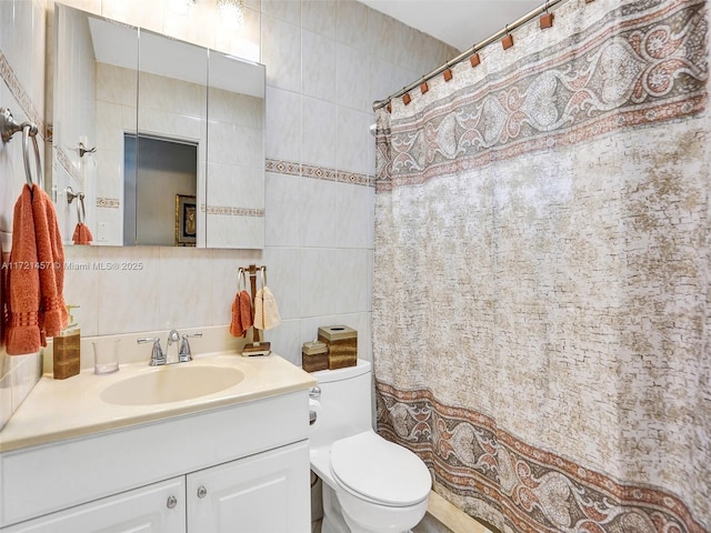 bathroom featuring decorative backsplash, vanity, tile walls, and toilet