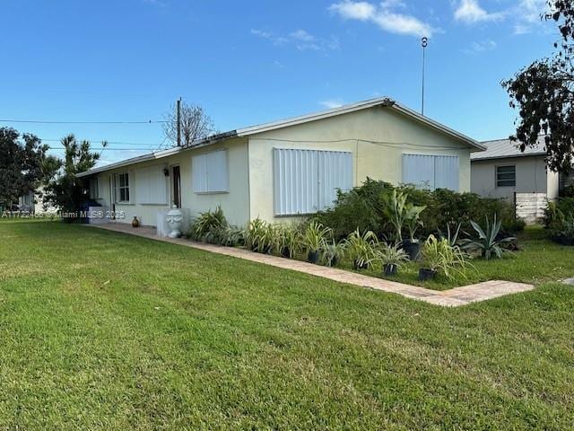 view of home's exterior with a yard