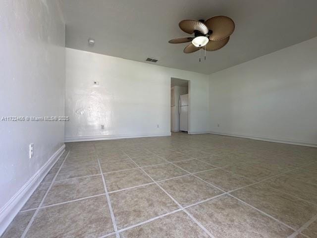 spare room featuring light tile patterned floors and ceiling fan