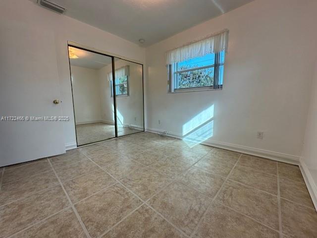 unfurnished bedroom with a closet