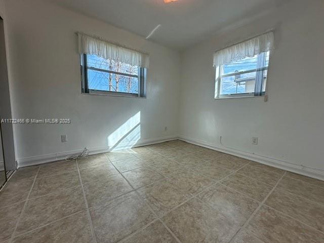 spare room with tile patterned floors