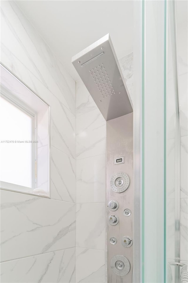 interior details with a tile shower