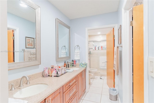 bathroom with tile patterned floors, walk in shower, vanity, a bidet, and toilet