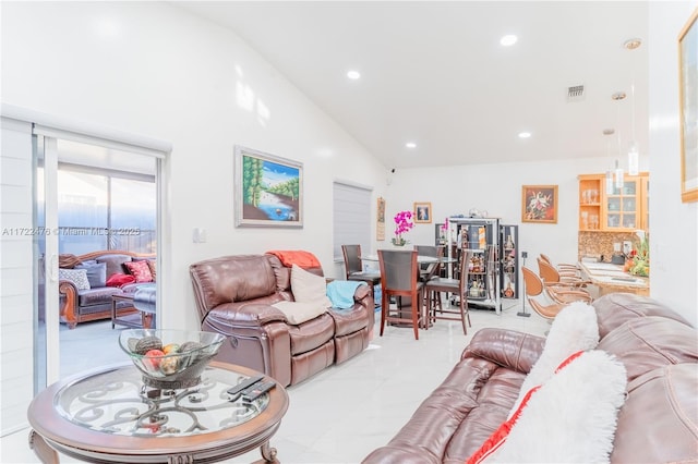 living room featuring high vaulted ceiling and light tile patterned floors