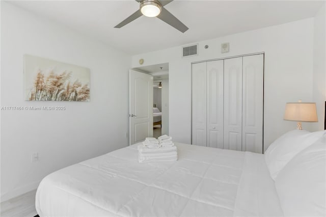 bedroom with ceiling fan and a closet